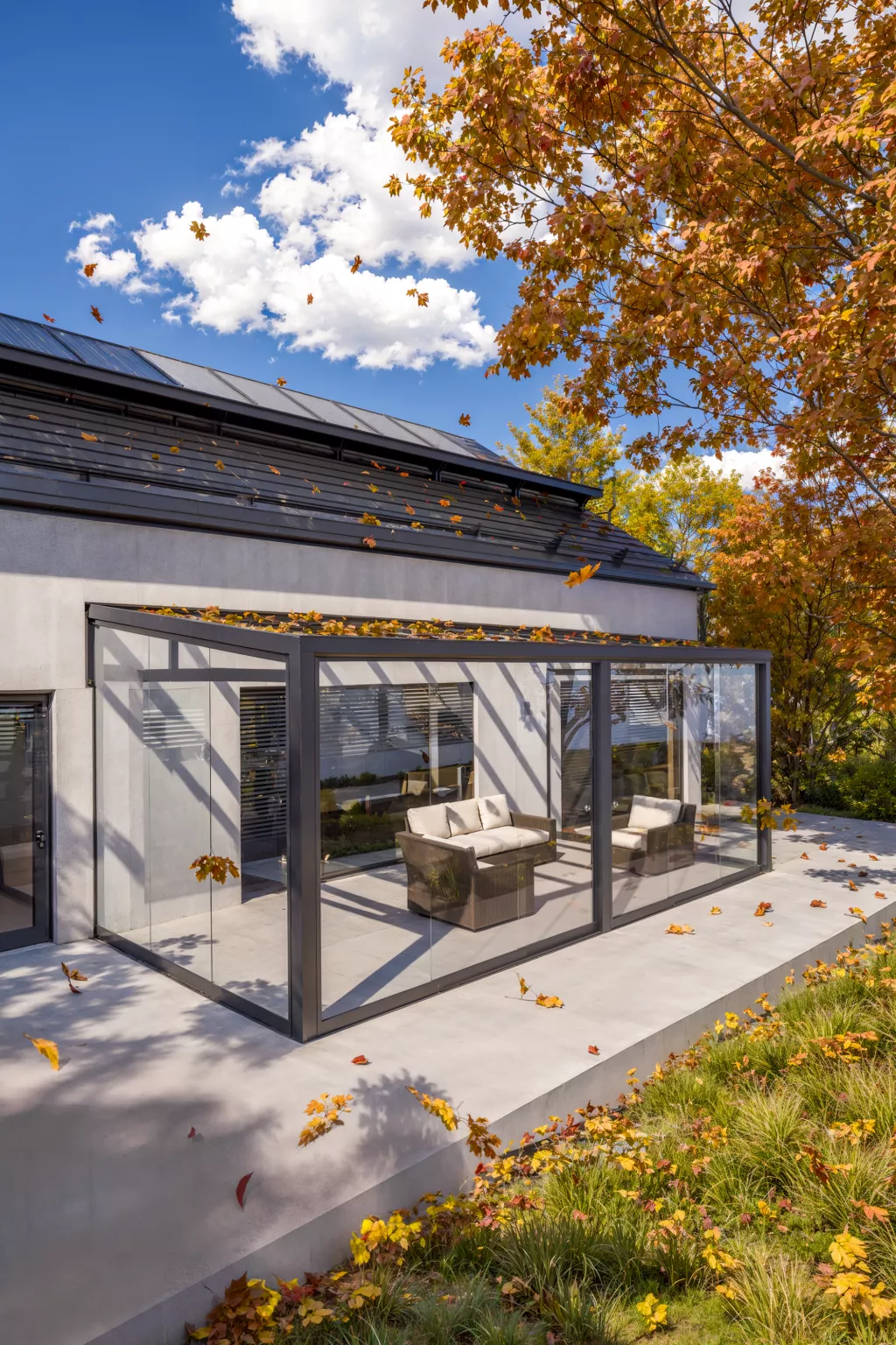 Kaltwintergarten aus Aluminium mit gerahmter Verglasung im Herbst
